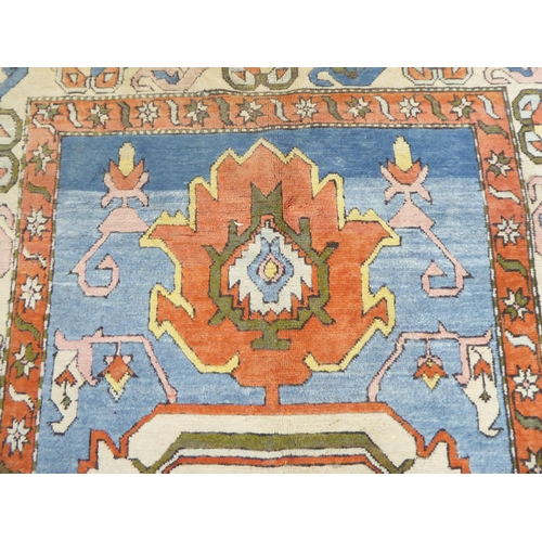 96 - A Turkish Azari style rug, decorated in bright colours with stylised designs  69