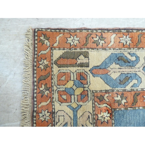 96 - A Turkish Azari style rug, decorated in bright colours with stylised designs  69