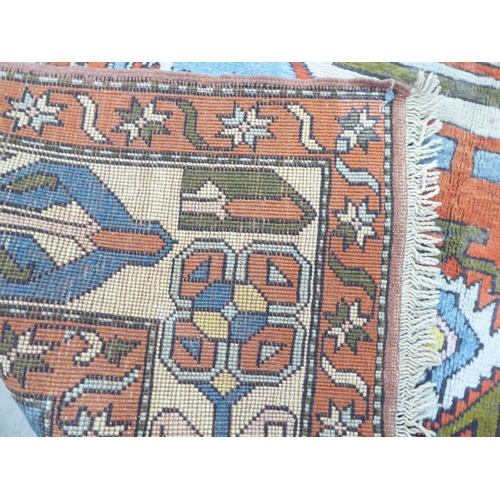 96 - A Turkish Azari style rug, decorated in bright colours with stylised designs  69