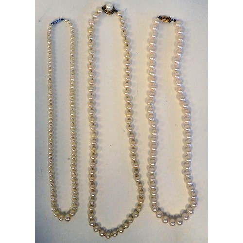 38 - Three single strand pearl necklaces, each on a yellow metal clasp