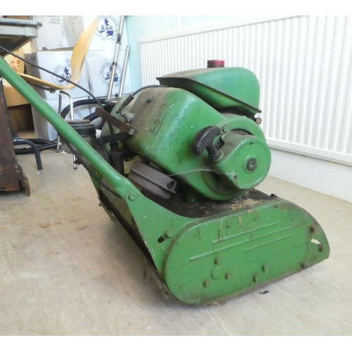 11 - A vintage petrol driven cylindrical lawn mower with a grass box