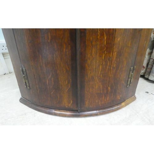 34 - A George III oak quadrant corner cabinet  43