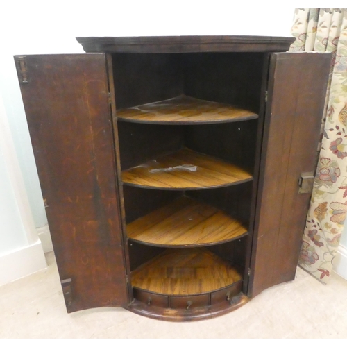 34 - A George III oak quadrant corner cabinet  43