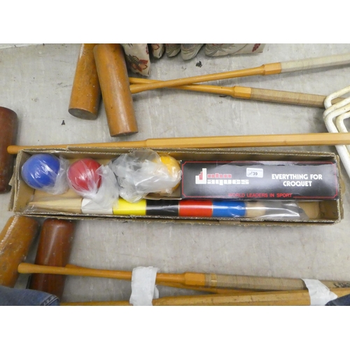 39 - Six croquet mallets; four balls and pegs 