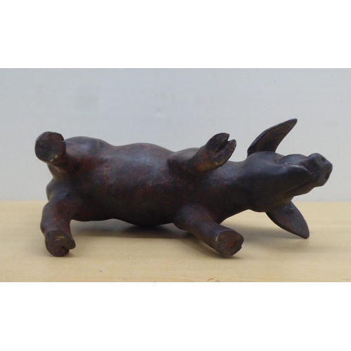 60 - A cast bronze model, a piglet  6.5