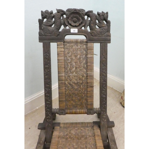 66 - An early/mid 20thC Burmese carved hardwood and wicker panelled folding veranda chair 