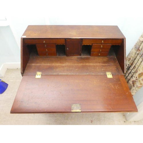 7 - A 19thC mahogany bureau, the fall flap over two short/three graduated long drawers, raised on bracke... 