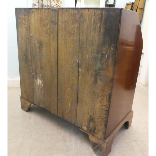 7 - A 19thC mahogany bureau, the fall flap over two short/three graduated long drawers, raised on bracke... 