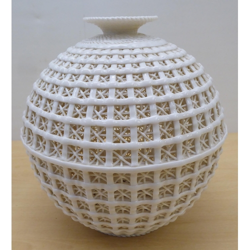 74 - A cream coloured porcelain vase, fashioned as a woven basket of waisted baluster form  11