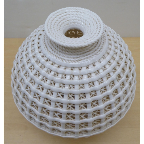 74 - A cream coloured porcelain vase, fashioned as a woven basket of waisted baluster form  11