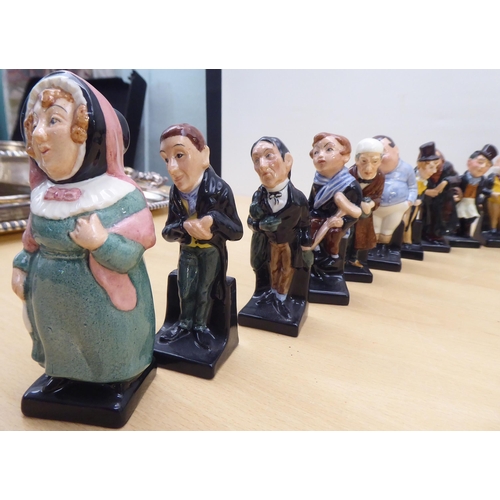 75 - Twenty-four Royal Doulton china figures from 'Oliver' and other Dickens figures  largest 4