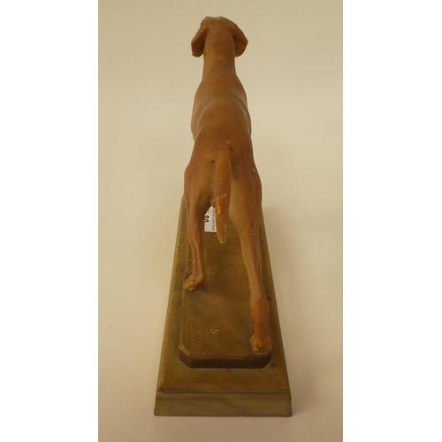 80 - A carved softwood sculpture, a gun dog, on a plinth  bears the signature Diller  6