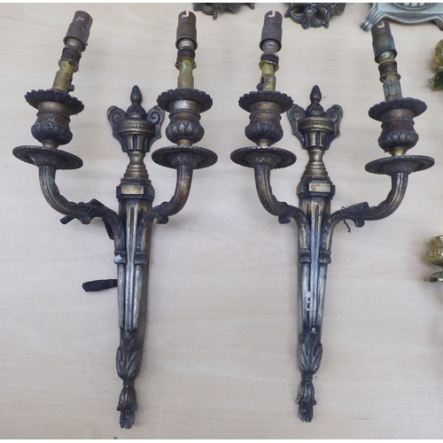 85 - 20thC lighting: to include a pair of cast antique finished brass twin branch appliques  13