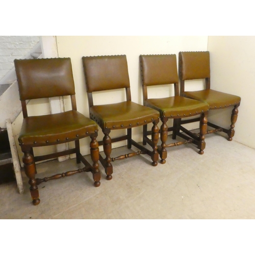 87 - A set of four 20thC Old English style oak and stained beech framed dining chairs with stud upholster... 