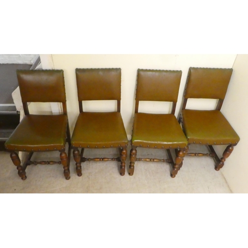 87 - A set of four 20thC Old English style oak and stained beech framed dining chairs with stud upholster... 