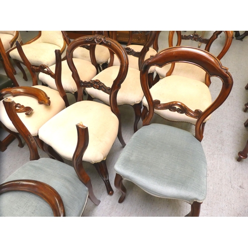 11 - A matched set of ten late Victorian carved mahogany framed balloon back dining chairs with overstuff... 