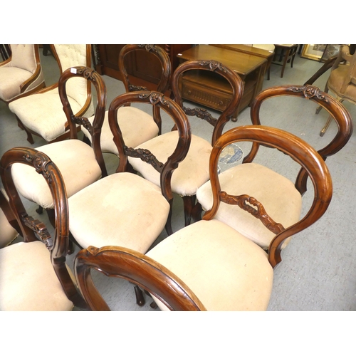 11 - A matched set of ten late Victorian carved mahogany framed balloon back dining chairs with overstuff... 