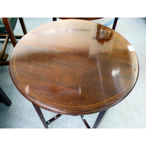 12 - An Edwardian crossbanded mahogany occasional table, raised on square, tapered legs  28