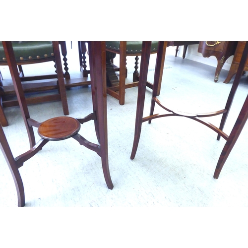 12 - An Edwardian crossbanded mahogany occasional table, raised on square, tapered legs  28