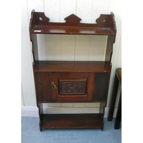 13 - A late Victorian mahogany hanging bookcase, incorporating a central cupboard  30