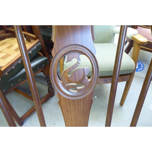 153 - An Ercol Golden Dawn beech and elm draw leaf dining table with a panelled top, raised on shaped tres... 