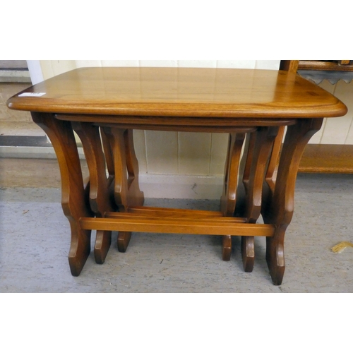 164 - A nesting set of three Ercol Golden Dawn beech and elm, trestle end coffee tables  largest 17