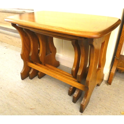 164 - A nesting set of three Ercol Golden Dawn beech and elm, trestle end coffee tables  largest 17