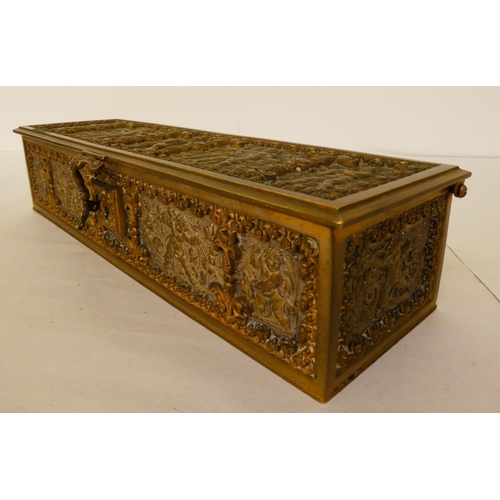 167 - A 19thC brass casket with a hinged lid and clasp, decorated with cherubic figures&nbsp; 3.5