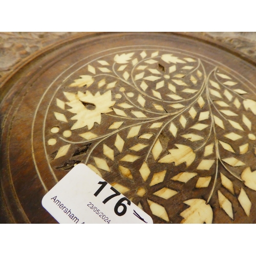 176 - An Indian carved teak side table with an inlaid bone central motif, raised on elephants' head suppor... 