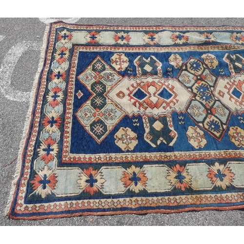 27 - A North Asian rug, decorated with geometric designs, on a multi-coloured ground  66