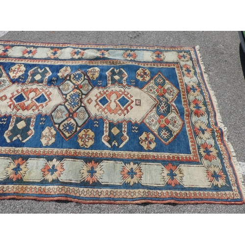 27 - A North Asian rug, decorated with geometric designs, on a multi-coloured ground  66