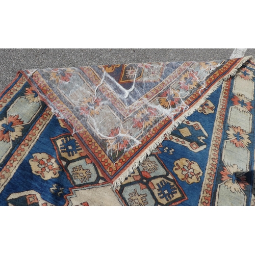 27 - A North Asian rug, decorated with geometric designs, on a multi-coloured ground  66