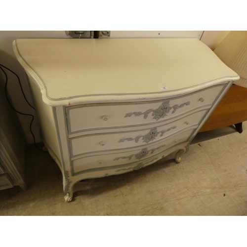 29 - A modern cream painted three drawer serpentine front commode, raised on cabriole legs  34