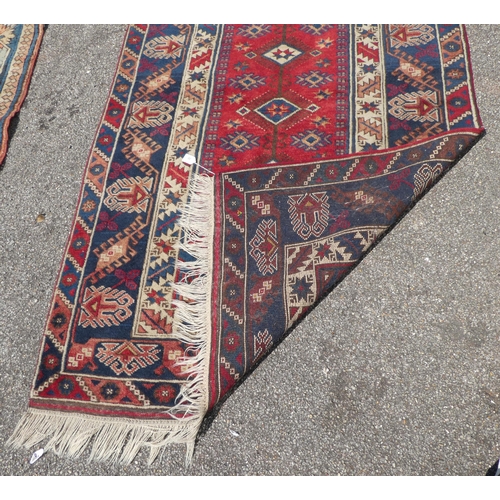 30 - A North Asian rug, decorated with geometric designs, on a multi-coloured ground  48