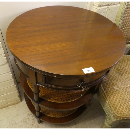 31 - A modern mahogany finished occasional table with a frieze drawer, over two caned platforms, raised o... 