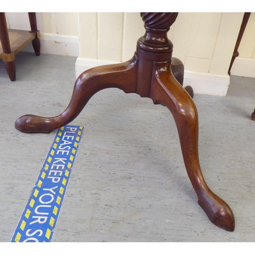 323 - A mid 19thC mahogany dumb waiter, raised on a turned column and tripod base  41