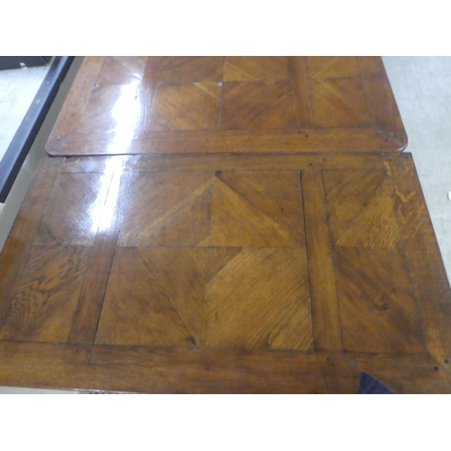 33 - A modern French oak dining table with a parquetry top, raised on cabriole legs  30