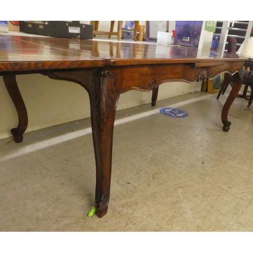 33 - A modern French oak dining table with a parquetry top, raised on cabriole legs  30