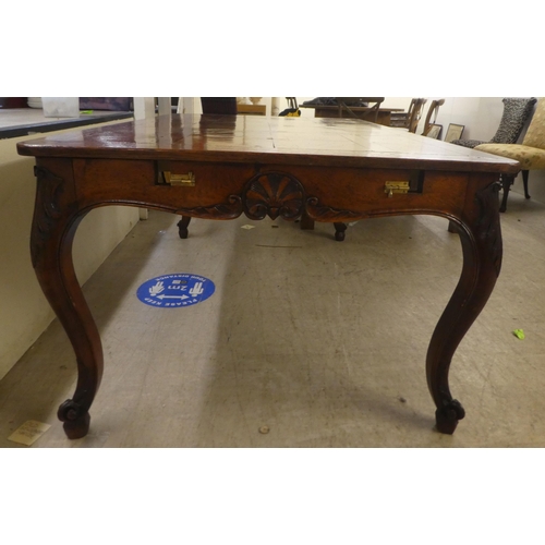 33 - A modern French oak dining table with a parquetry top, raised on cabriole legs  30