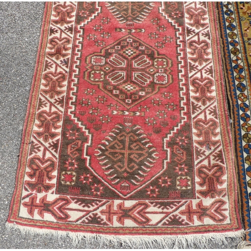 39 - Three rugs: to include a Turkoman, on a red ground  37