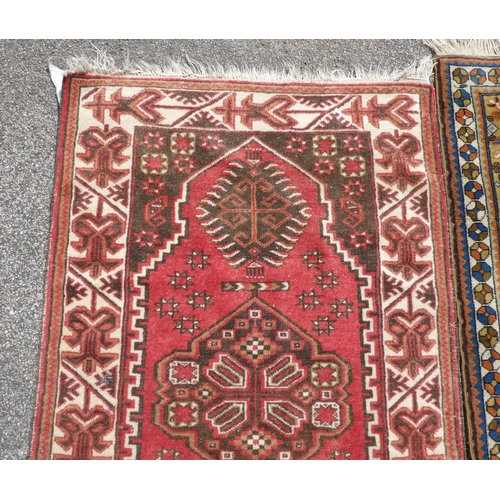 39 - Three rugs: to include a Turkoman, on a red ground  37