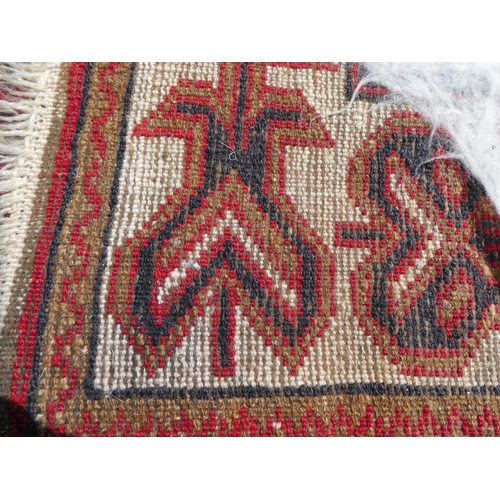 39 - Three rugs: to include a Turkoman, on a red ground  37