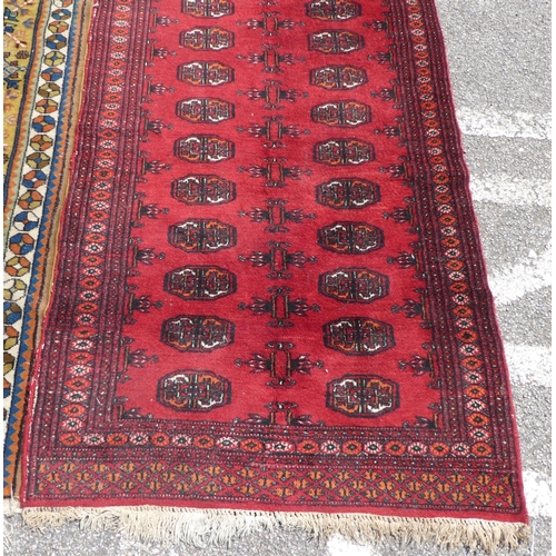 39 - Three rugs: to include a Turkoman, on a red ground  37