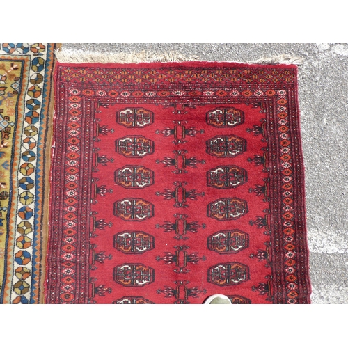 39 - Three rugs: to include a Turkoman, on a red ground  37