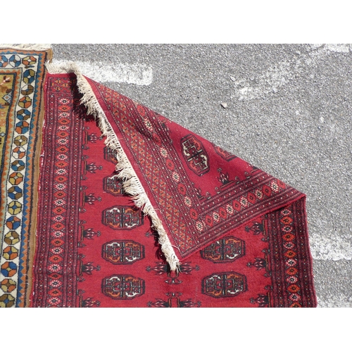 39 - Three rugs: to include a Turkoman, on a red ground  37