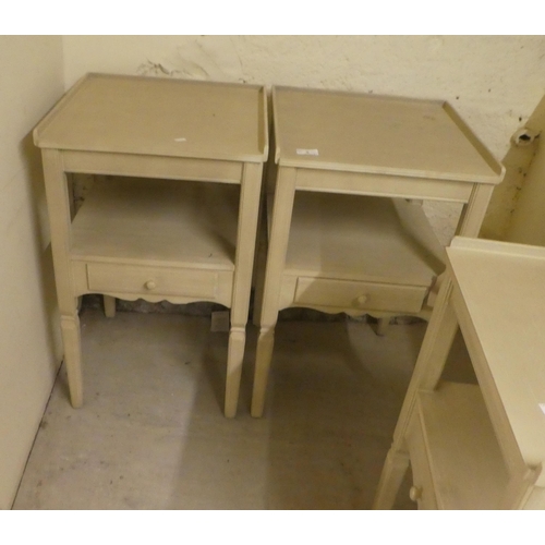 5 - A set of three modern cream painted bedside tables, each with a drawer, raised on square, tapered le... 