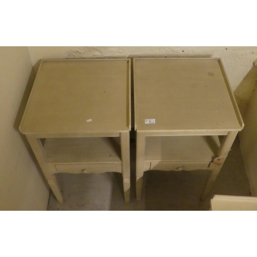 5 - A set of three modern cream painted bedside tables, each with a drawer, raised on square, tapered le... 