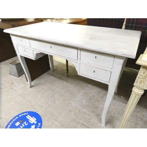 51 - A modern pale blue painted and distressed desk with five drawers, raised on splayed legs  30