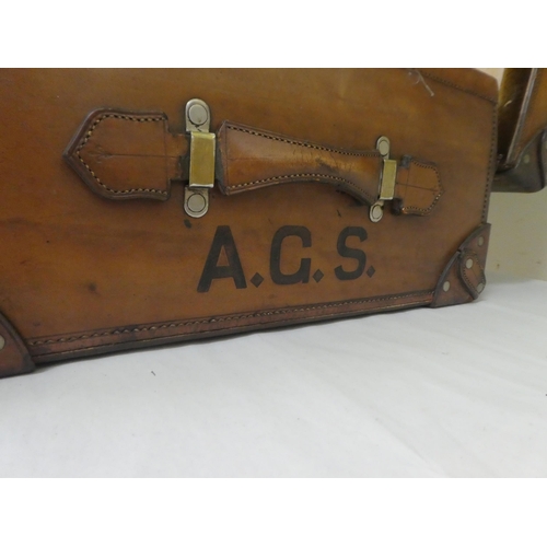 56 - A gentleman's stitched brown hide vanity case, the hinged lid enclosing a fitted interior with silve... 