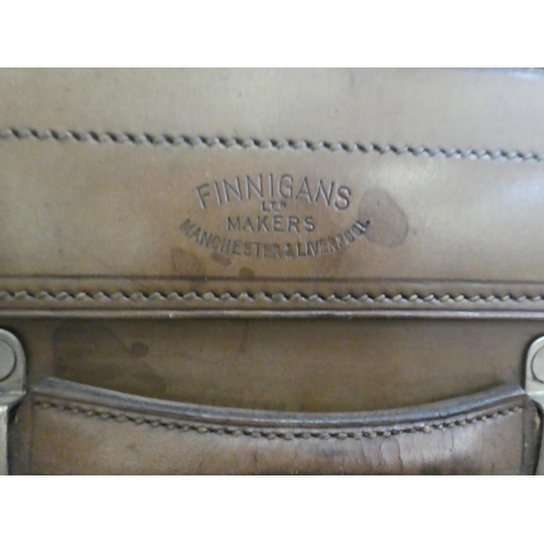 56 - A gentleman's stitched brown hide vanity case, the hinged lid enclosing a fitted interior with silve... 